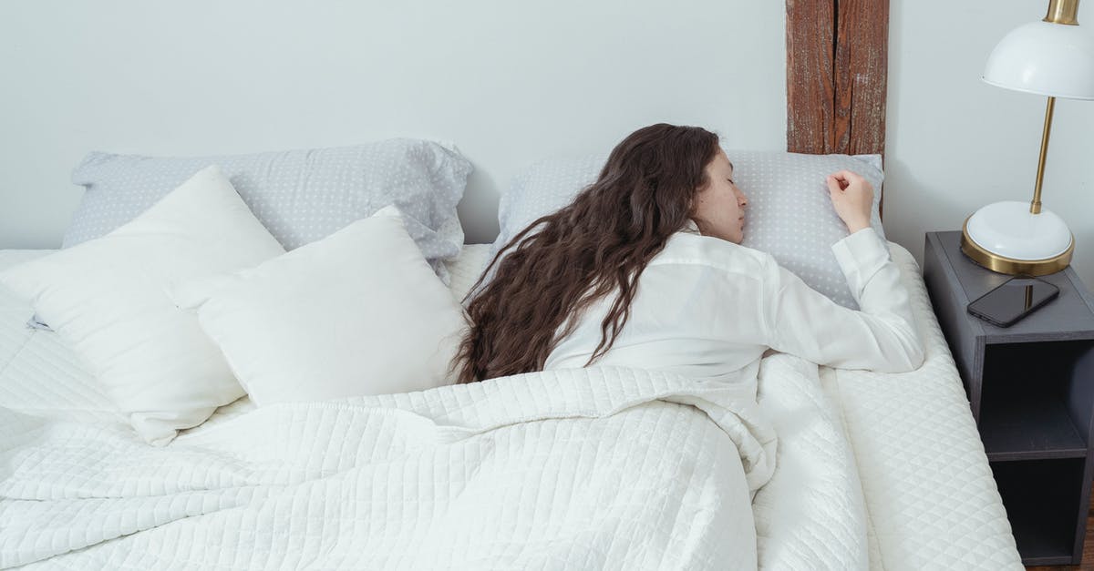 Getting from Pushkar to Ajmer early in the morning - Calm woman sleeping on belly on white bed Getting from Pushkar to Ajmer early in the morning - Calm woman sleeping on belly on white bed