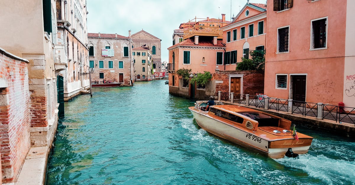 Getting from Split, Croatia to Venice, Italy - Orange Powerboat Between Medium Rise Buildings Getting from Split, Croatia to Venice, Italy - Orange Powerboat Between Medium Rise Buildings