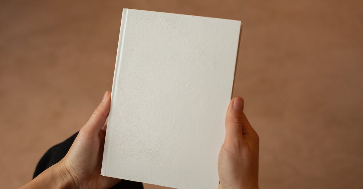 Getting from Toronto to New York - Person holding hardcover book with blank cover Getting from Toronto to New York - Person holding hardcover book with blank cover