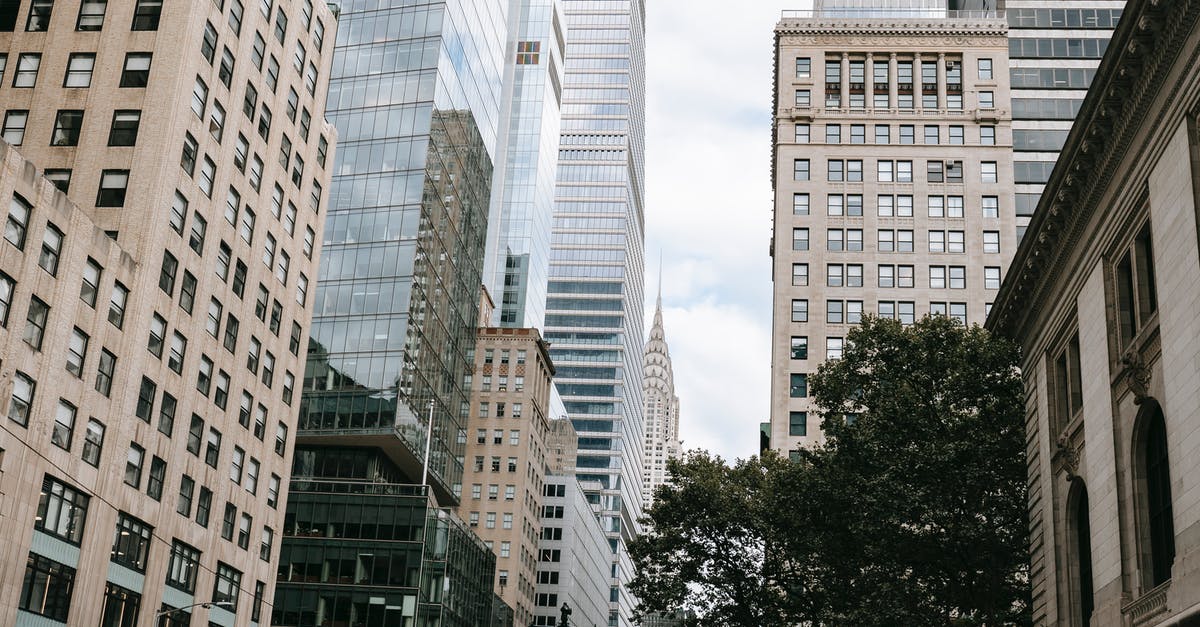 Getting Married to a US Citizen, Can I apply for US immigration visa from Sweden where I live on a temporary residence permit [closed] - Modern buildings with reflecting walls in city