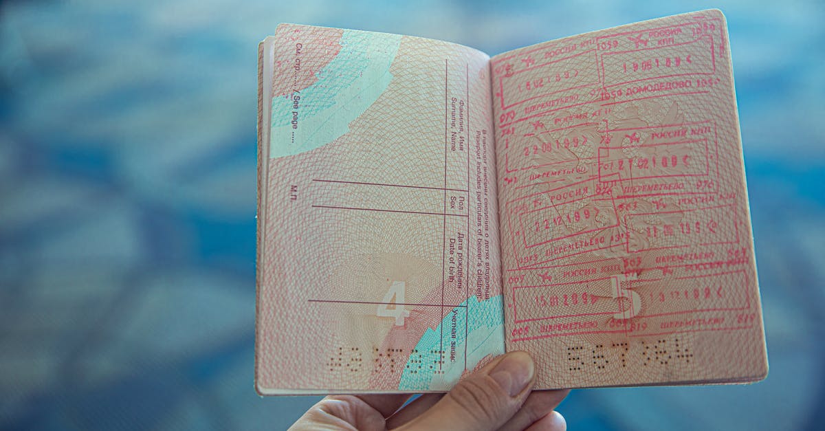 Gibraltar to Spain border passport stamping - Person Holding an Opened Passport Gibraltar to Spain border passport stamping - Person Holding an Opened Passport