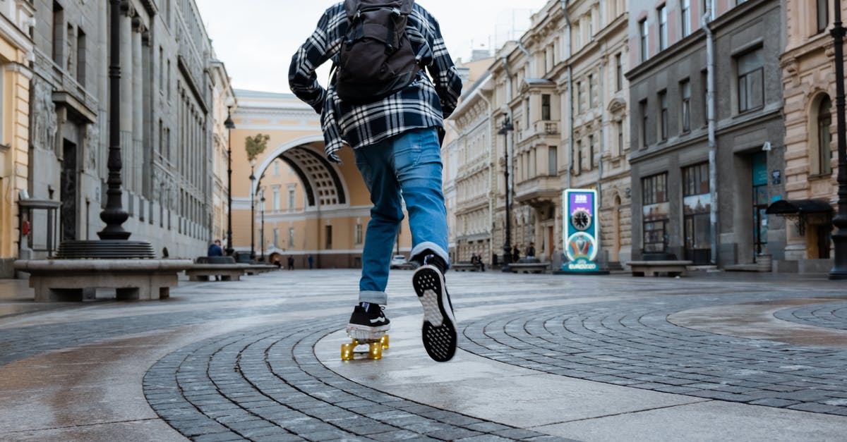 Going back to Russia with another passport (maybe) - Man in Black Leather Jacket and Blue Denim Jeans Walking on Pedestrian Lane Going back to Russia with another passport (maybe) - Man in Black Leather Jacket and Blue Denim Jeans Walking on Pedestrian Lane