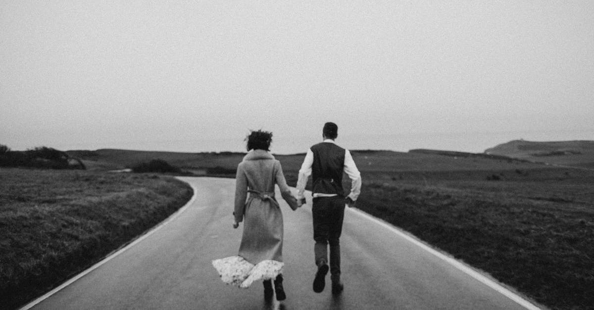 Going back to the USA on ESTA after K1 visa and marriage - Grayscale Photo of Couple Walking on Road
