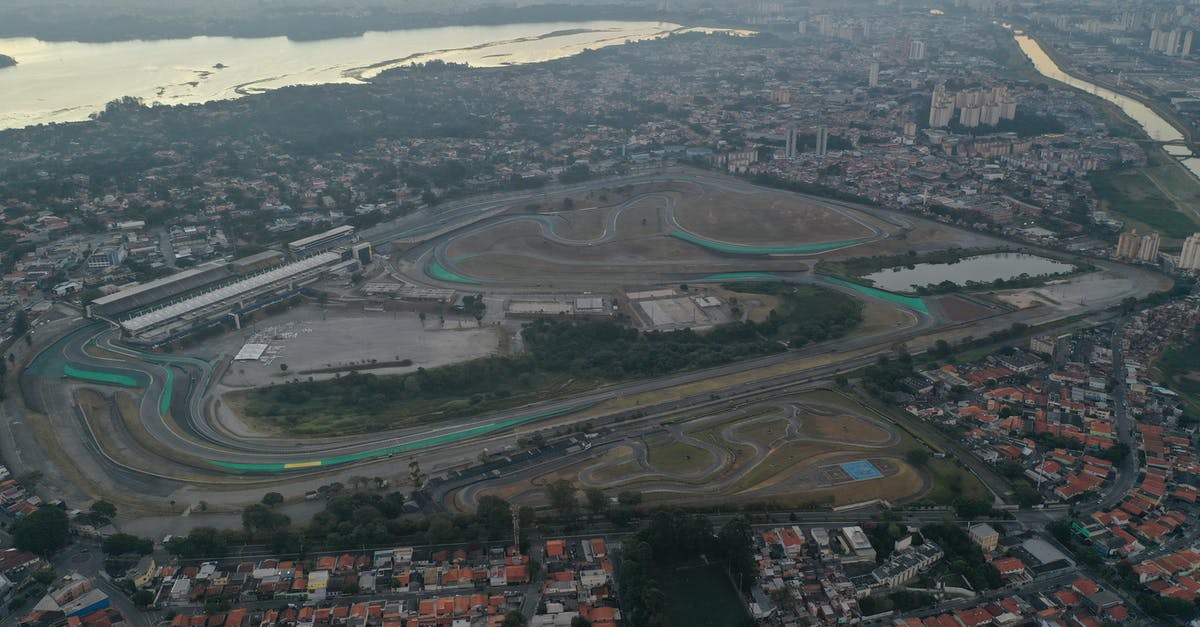 Going to Argentina from Brazil without a Brazilian entry stamp - Aerial view of autodrome between residential buildings and river in Brazil in daylight Going to Argentina from Brazil without a Brazilian entry stamp - Aerial view of autodrome between residential buildings and river in Brazil in daylight