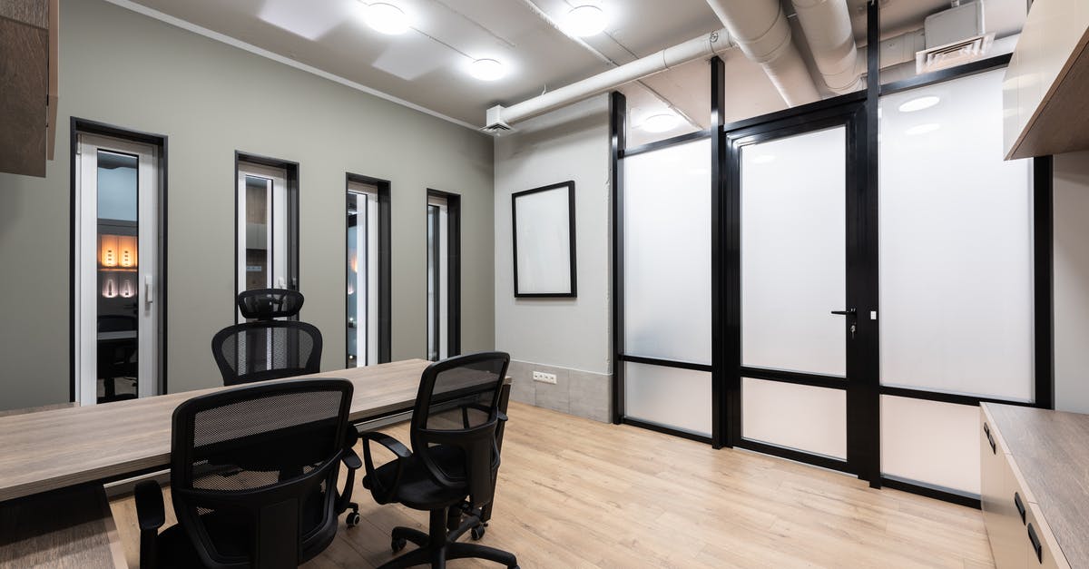 Going to New Delhi for a conference. Where to drink/get water? - Wooden table and black office chairs placed in spacious room in new contemporary workplace Going to New Delhi for a conference. Where to drink/get water? - Wooden table and black office chairs placed in spacious room in new contemporary workplace