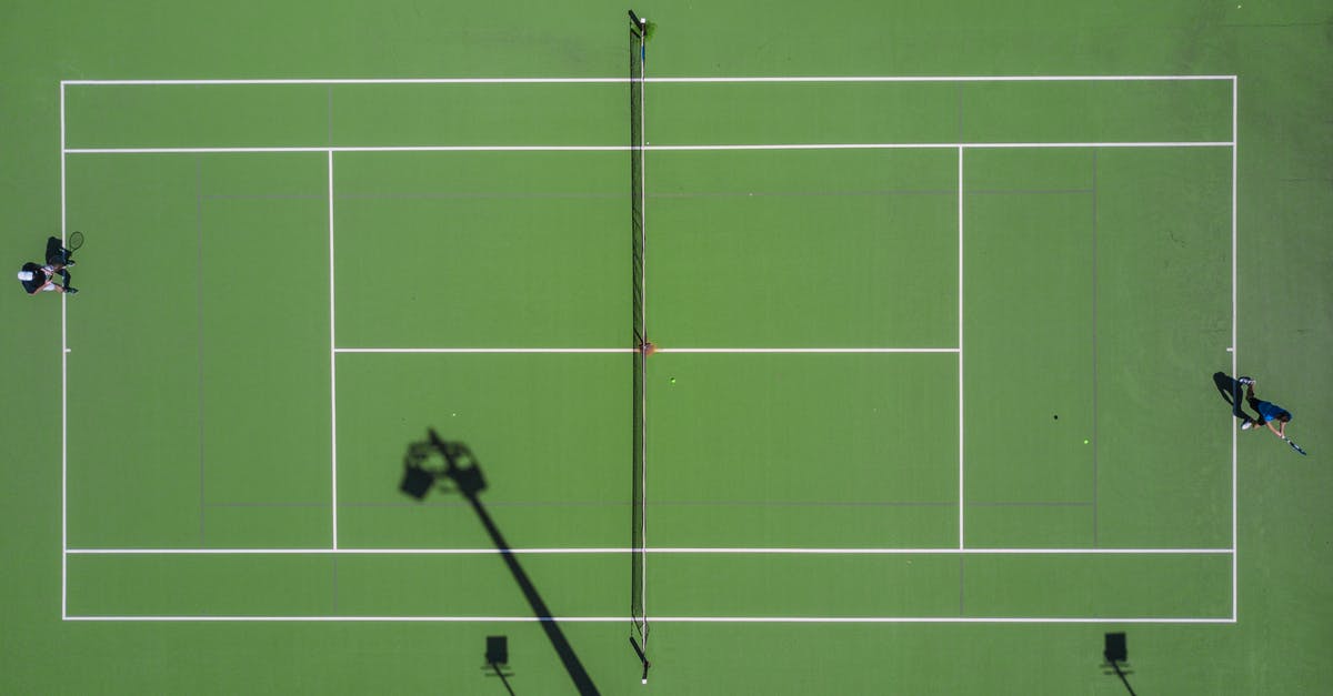 Going to the Wimbledon tennis championships while in London - Two Person Playing Tennis Going to the Wimbledon tennis championships while in London - Two Person Playing Tennis