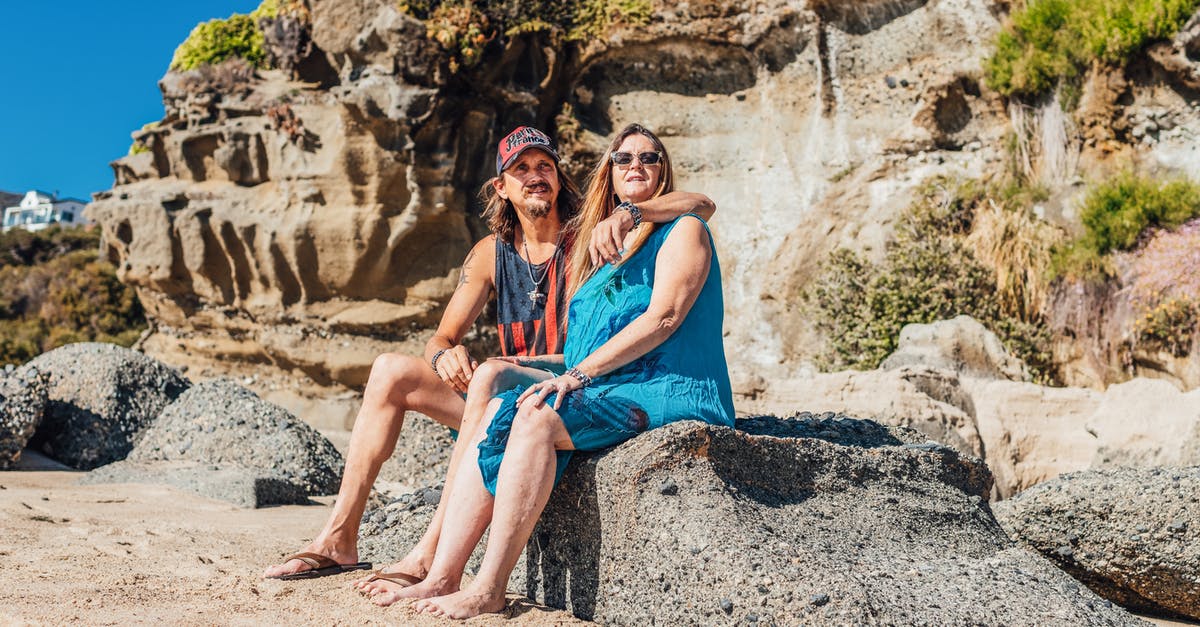 Good destinations to travel as a family with a 2 year old [closed] - Woman in Blue Sleeveless Dress Sitting on Rock