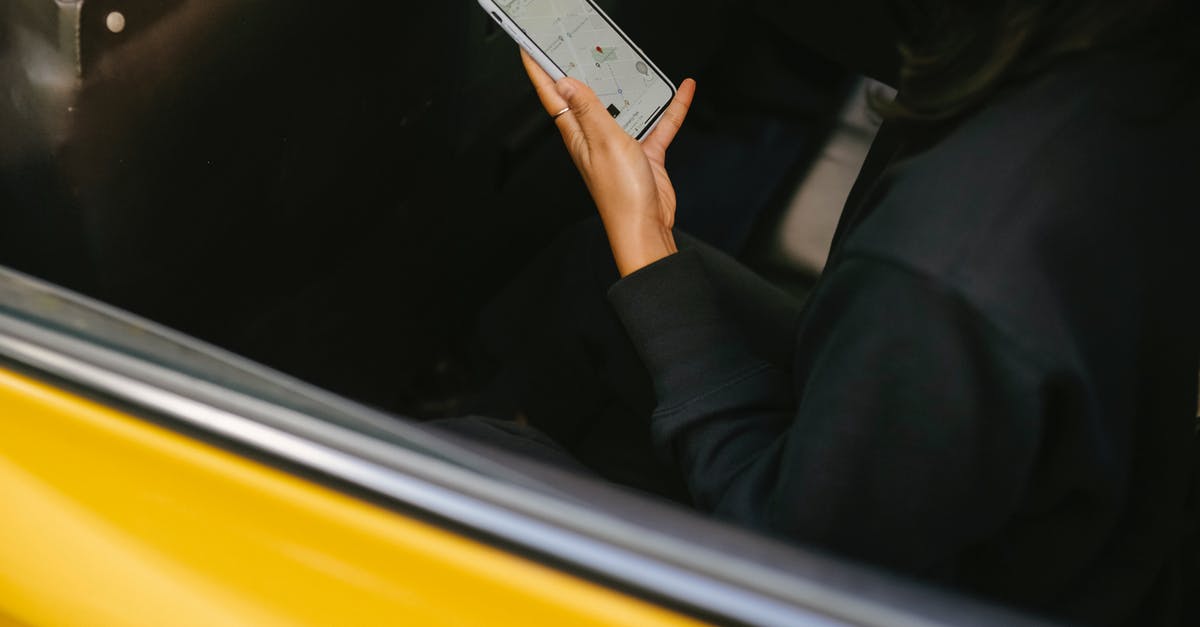 Good GPS device to tracking my travels? - Crop passenger with navigator app on smartphone in taxi vehicle Good GPS device to tracking my travels? - Crop passenger with navigator app on smartphone in taxi vehicle