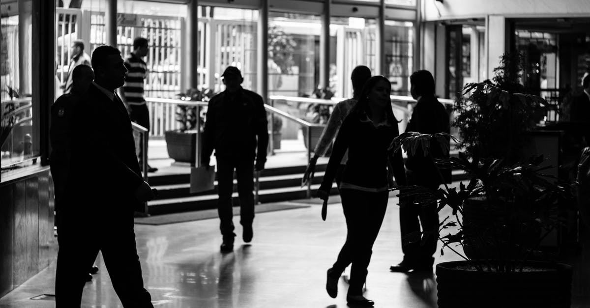 Group travel in the train in the Netherlands, how does it work? - Grayscale Photo of People in Building Group travel in the train in the Netherlands, how does it work? - Grayscale Photo of People in Building