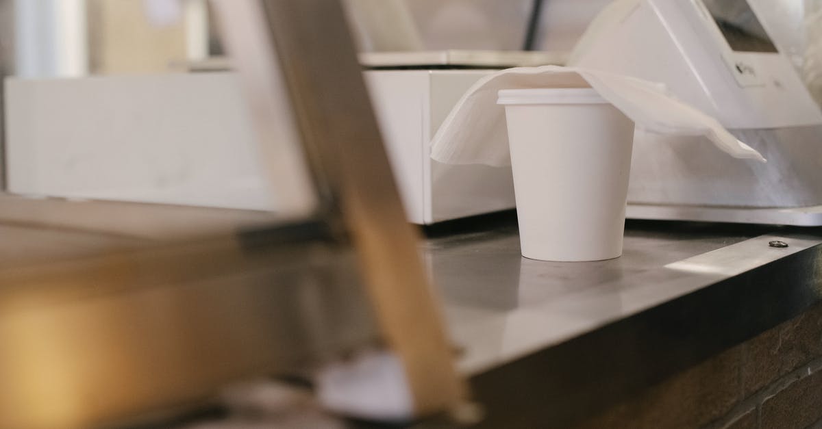 GRU (Guarulhos) Check In without going through Immigration (Terminal 3) - Paper cup of coffee on counter GRU (Guarulhos) Check In without going through Immigration (Terminal 3) - Paper cup of coffee on counter