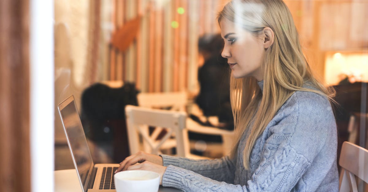 GRU (Guarulhos) Check In without going through Immigration (Terminal 3) - Serious young woman using netbook while having hot drink in modern cafe GRU (Guarulhos) Check In without going through Immigration (Terminal 3) - Serious young woman using netbook while having hot drink in modern cafe