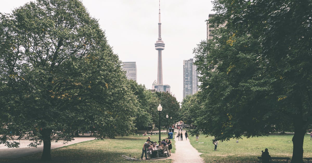 H1B Visa holder travel to Niagara Passing through Canada Via Road - People Walking on Park Near Tower H1B Visa holder travel to Niagara Passing through Canada Via Road - People Walking on Park Near Tower
