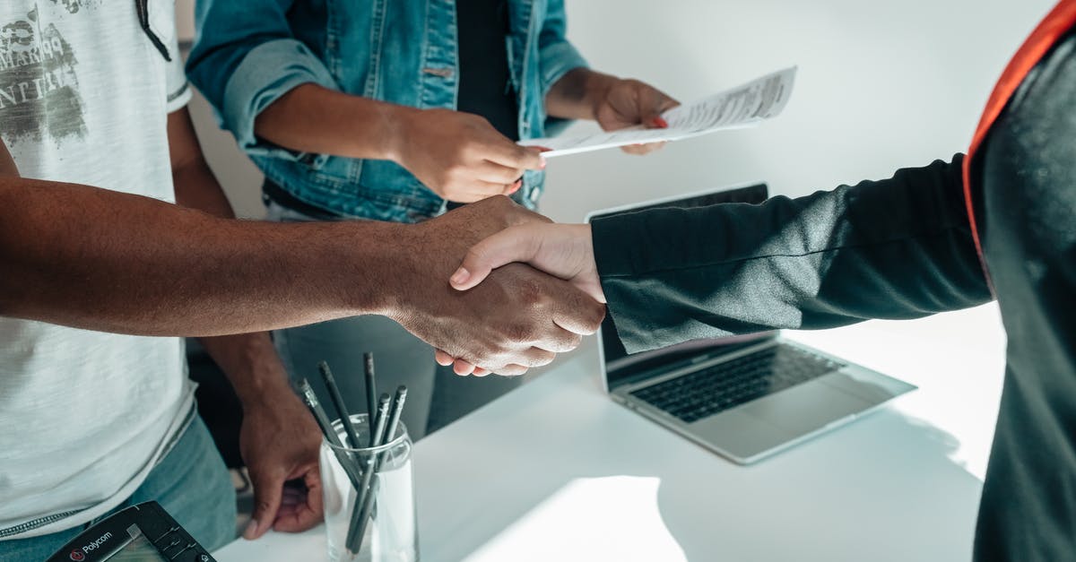 Handshake while holding own right elbow - People Doing a Handshake Handshake while holding own right elbow - People Doing a Handshake