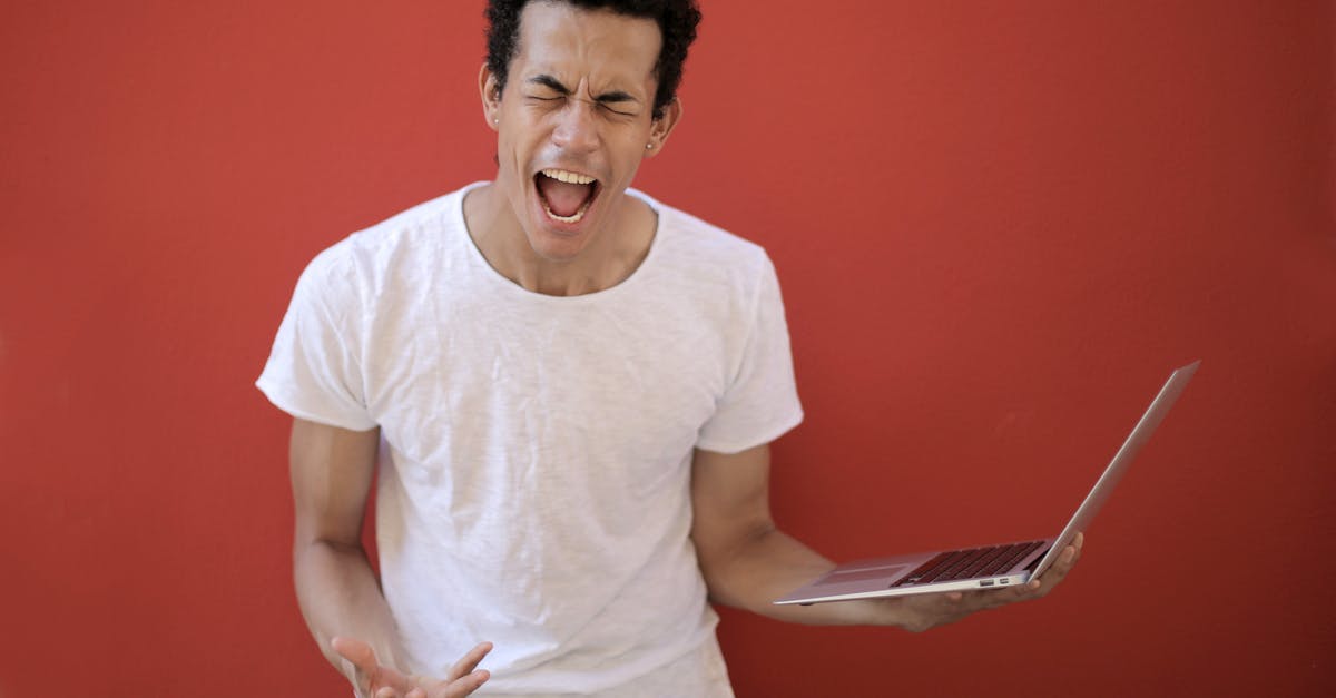 Has anyone ever used their paper copy of their ID to get their Greyhound ticket? [closed] - Guy with opened mouth and closed eyes screaming madly while standing with laptop against red background