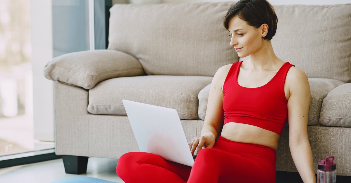 Have anyone experienced inspection of their laptop or digital media content? [duplicate] - Smiling female with short hair in activewear sitting near sofa with bottle of water on mat in living room and browsing laptop