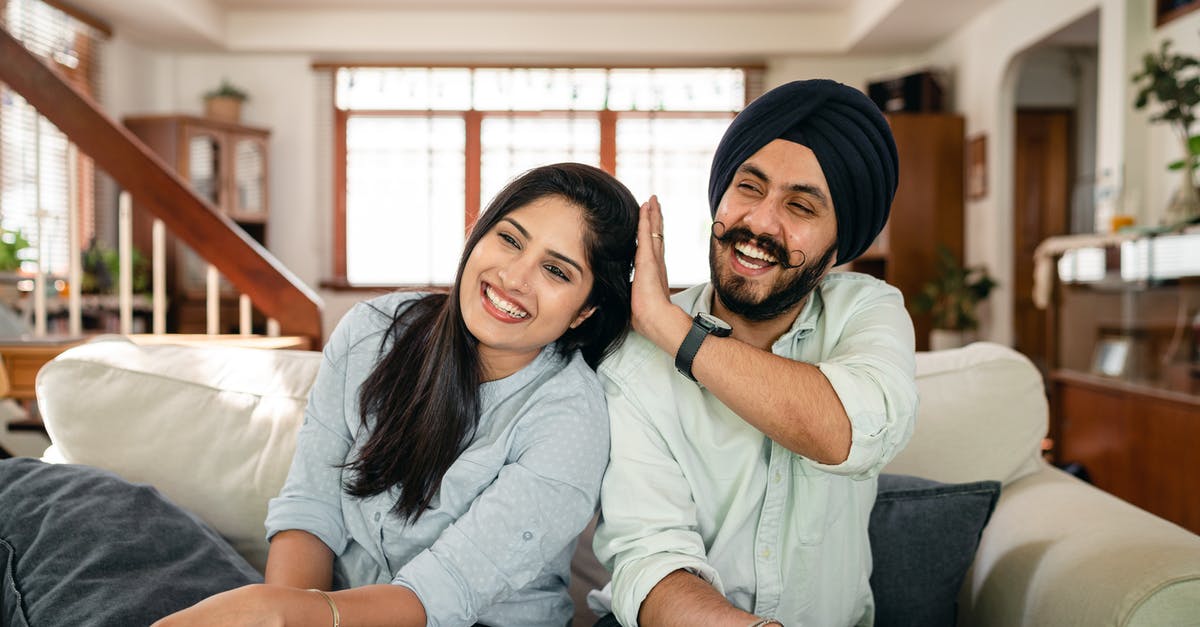Have I been granted the UK spouse visa? - Playful Indian spouses having fun on sofa during weekend Have I been granted the UK spouse visa? - Playful Indian spouses having fun on sofa during weekend