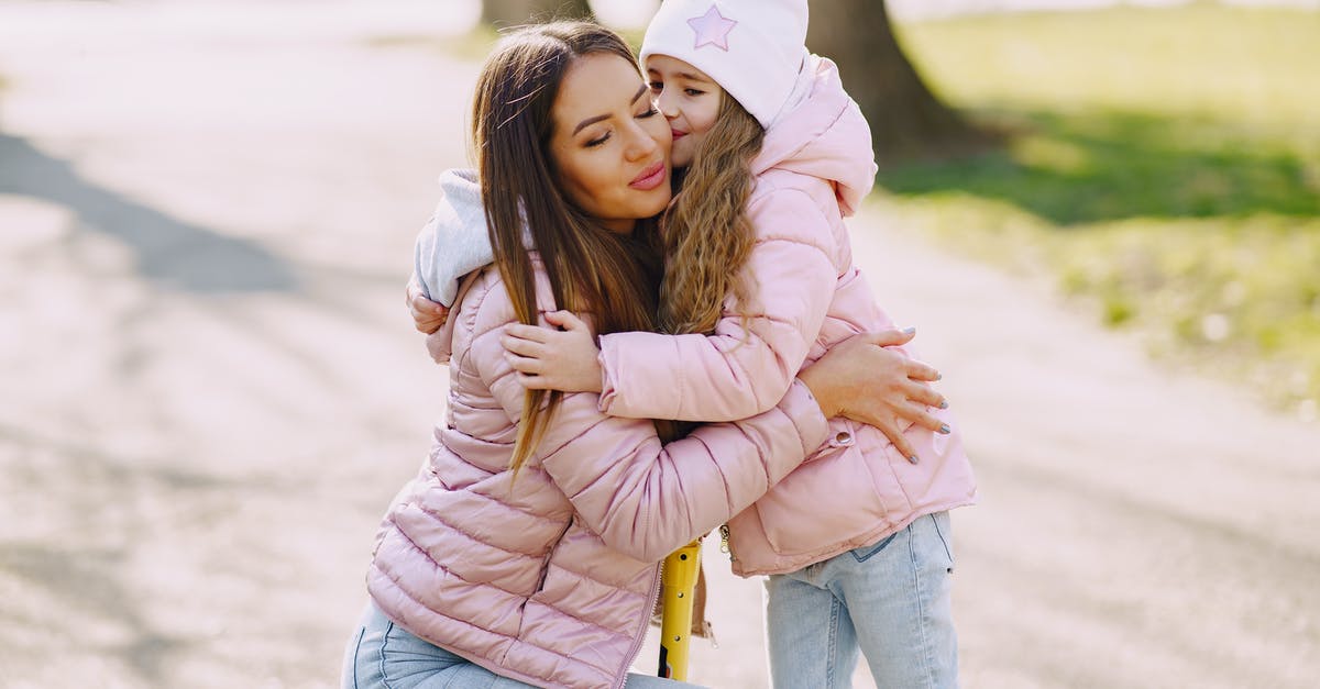 Having J1 and F1 at the same time [closed] - Girl kissing and hugging mom in park