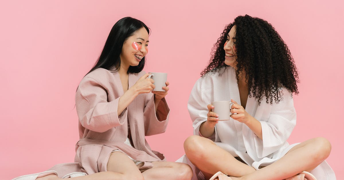 Having Schengen visa for Germany. Transiting through Paris is possible without having transit visa? [duplicate] - Two women in bathrobes sitting on floor and having break with cup of tea