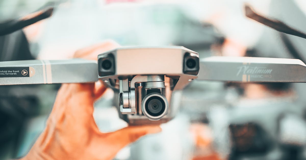 Heathrow change in terminal (from 5 to 3) flight UK Border control check? - Faceless man checking drone with video camera on urban background in modern city in soft daylight