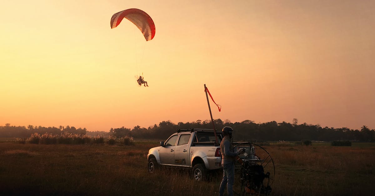 Hertz rental - is it ok to pick up car 2 hours earlier than voucher says? - Man Riding Parachute during Golden Hour