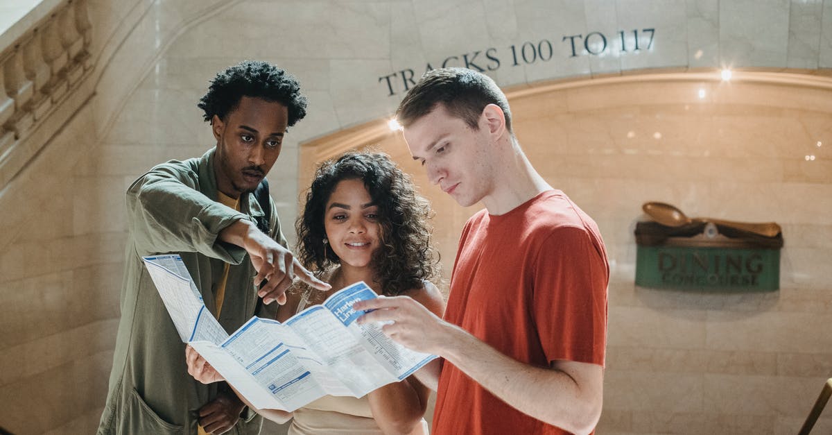 Highest point in NYC that may be reached for free? - Young focused diverse students exploring map in railway station Highest point in NYC that may be reached for free? - Young focused diverse students exploring map in railway station
