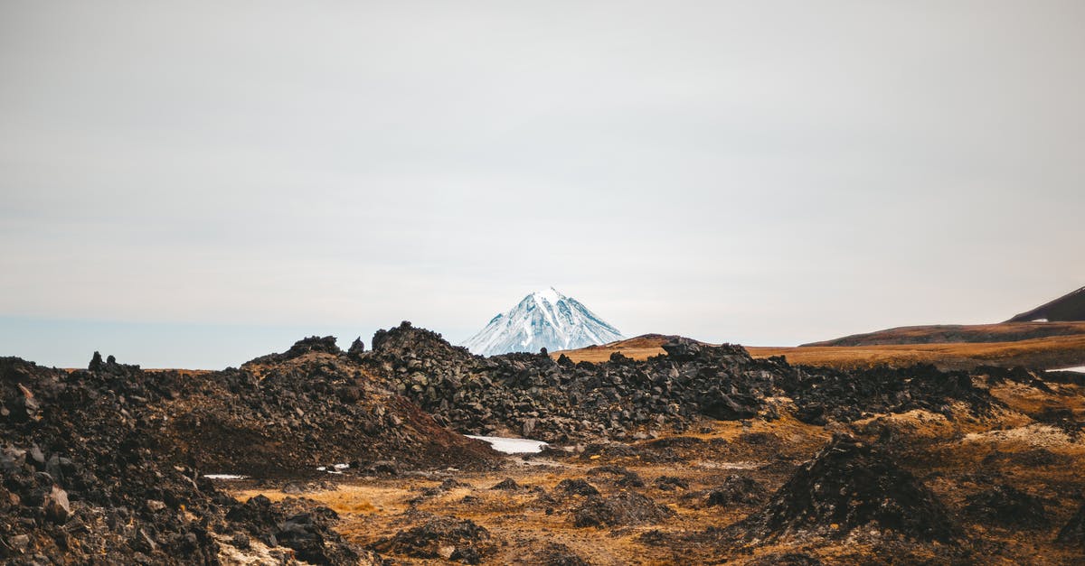 Hiking across Iceland - Mountainous valley under cloudy gray sky Hiking across Iceland - Mountainous valley under cloudy gray sky