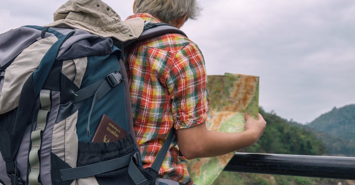Hiking map for Hokkaido and/or other resources - Man Holding Green and Brown Map Hiking map for Hokkaido and/or other resources - Man Holding Green and Brown Map