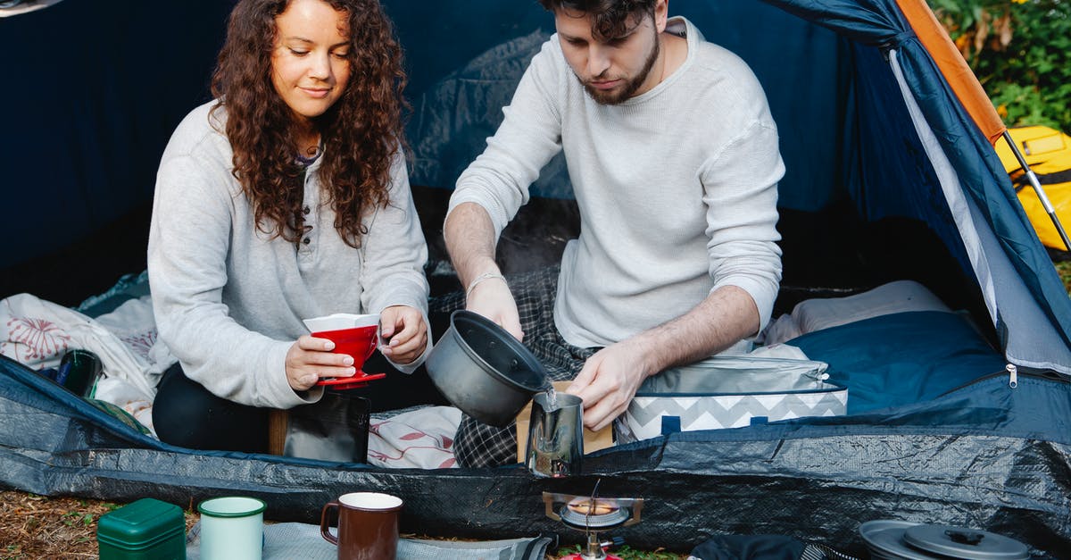 Hiking near Barcelona - or alternative hiking cities close-by? - Crop couple of travelers preparing coffee in tent Hiking near Barcelona - or alternative hiking cities close-by? - Crop couple of travelers preparing coffee in tent