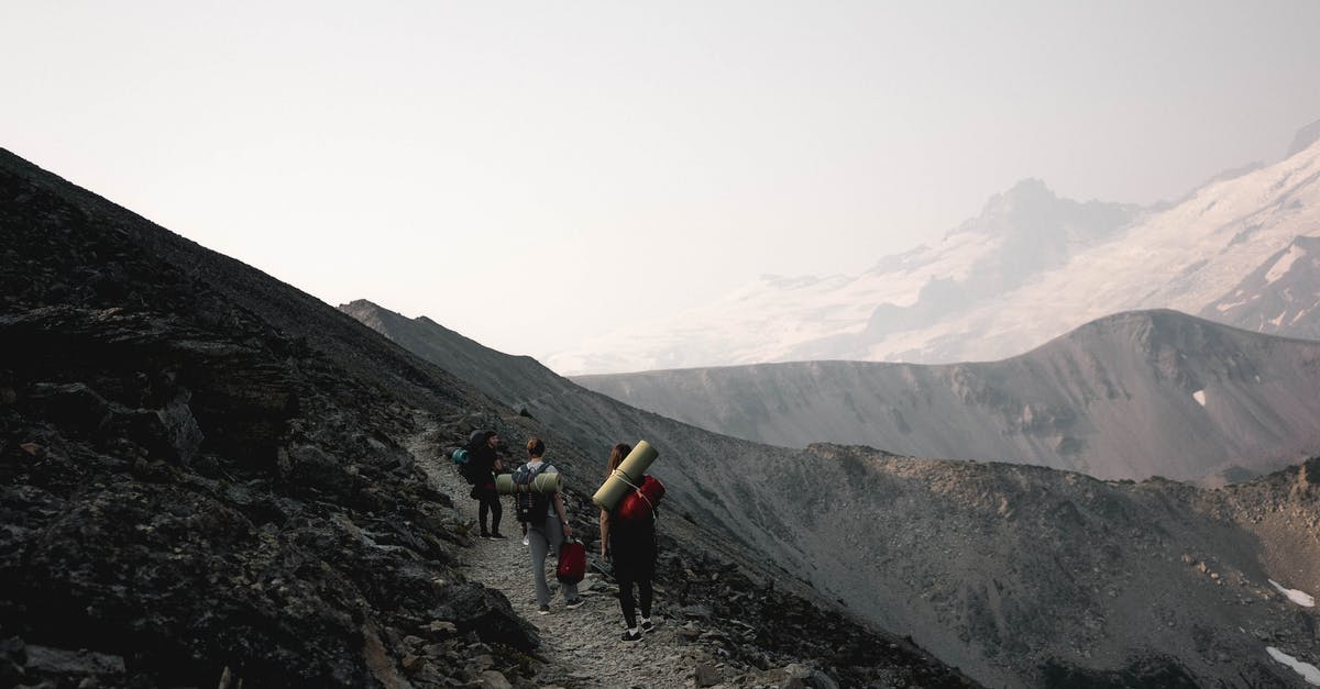 Hiking routes near Embrun - Unrecognizable travelers walking on rocky slope Hiking routes near Embrun - Unrecognizable travelers walking on rocky slope