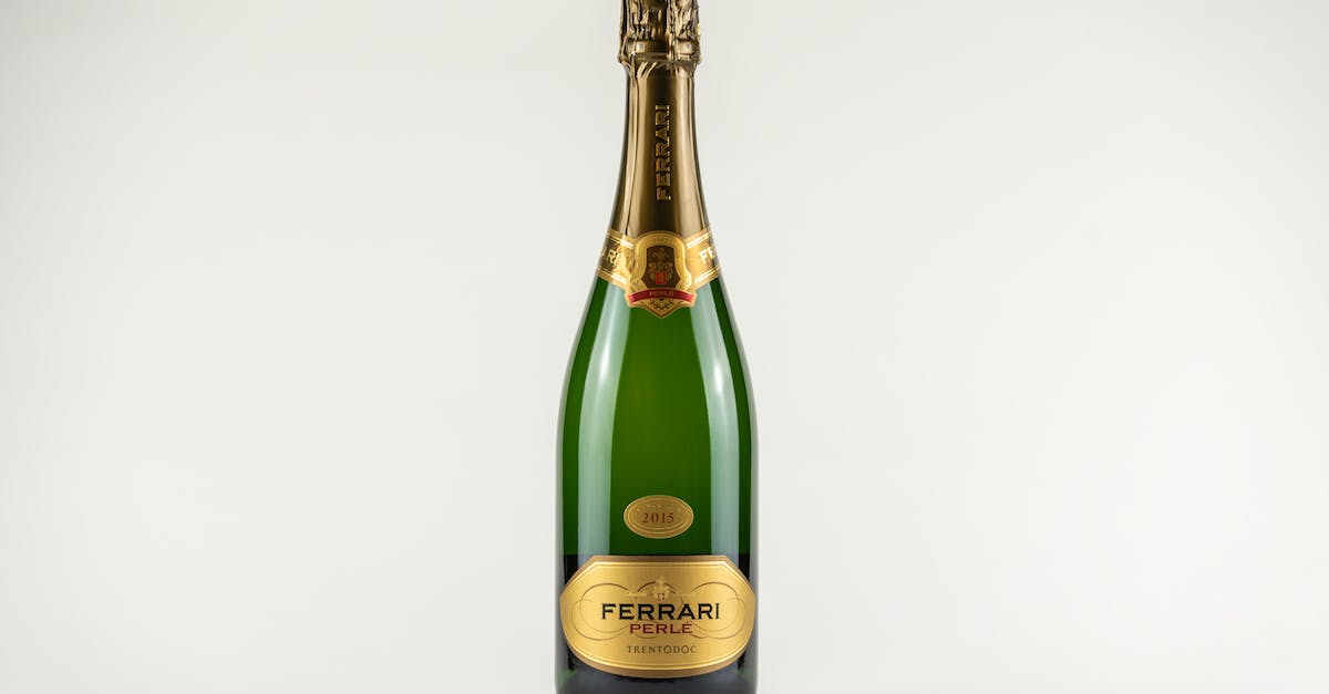 Hiring a Ferrari in Italy - Green Champagne Bottle on White Surface Hiring a Ferrari in Italy - Green Champagne Bottle on White Surface