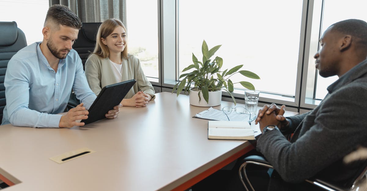 Hiring a solicitor for uk visit visa - Man in Blue Long Sleeve Shirt Holding a Black Tablet Hiring a solicitor for uk visit visa - Man in Blue Long Sleeve Shirt Holding a Black Tablet