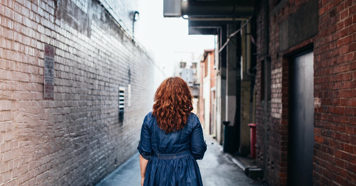 Holiday visit to UK with a C-Visit visa which I got for a business trip that never happened; meantime I left the company that backed my application - Anonymous stylish woman standing on street in old city district Holiday visit to UK with a C-Visit visa which I got for a business trip that never happened; meantime I left the company that backed my application - Anonymous stylish woman standing on street in old city district