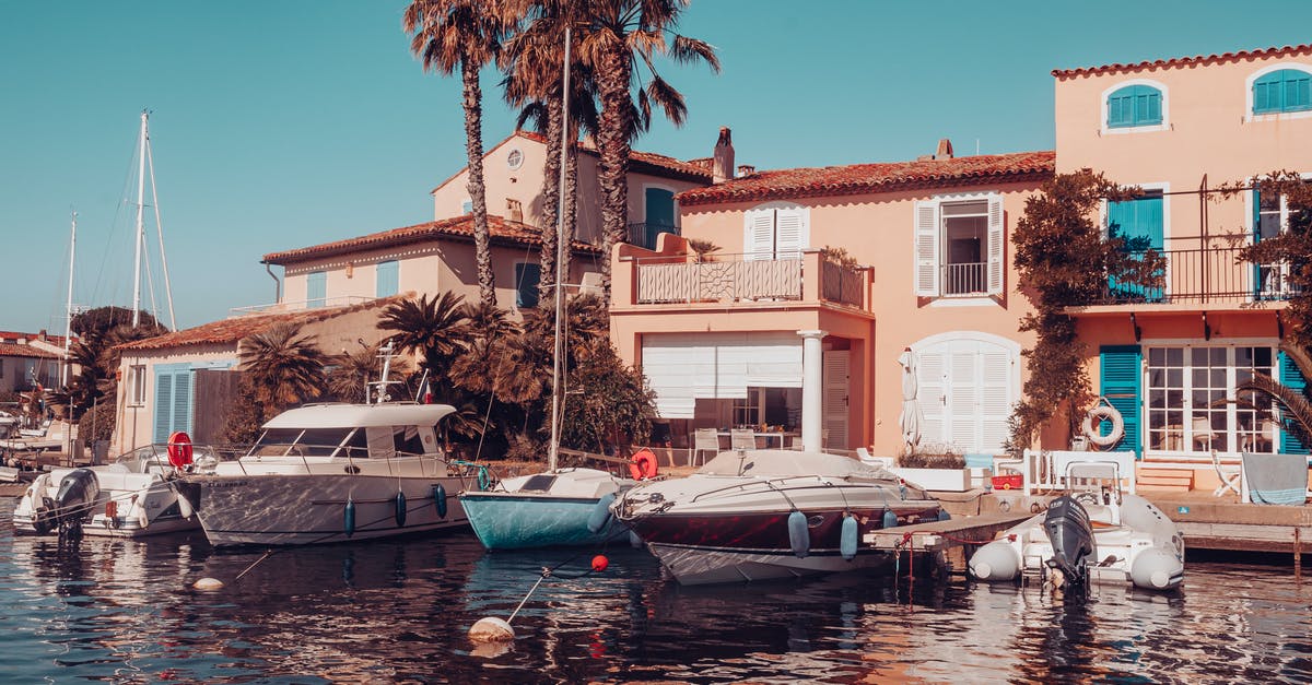 Hotel quarantine in France - Building With Boats Docked Next To It Hotel quarantine in France - Building With Boats Docked Next To It