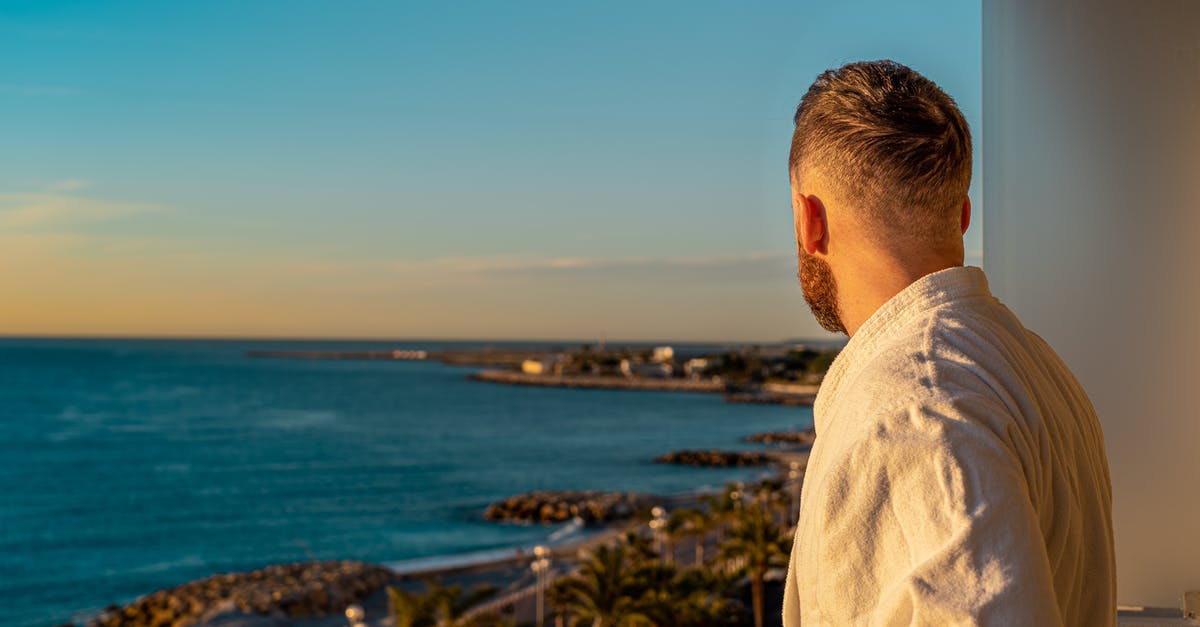 Hotel reservation cancelled after submitting my France visa application - Man Wearing Bathrobe While Looking Out in the Scenery