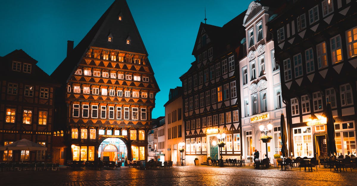 Hotel Reservation for Germany - Outdoor Dinette Set Near Brown Concrete Building at Nighttime Hotel Reservation for Germany - Outdoor Dinette Set Near Brown Concrete Building at Nighttime