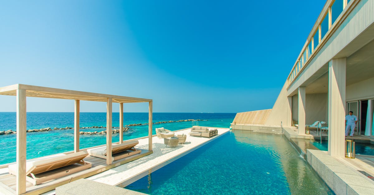 Hotel search site with "out of pocket" price [duplicate] - Architectural Photography of Gray Granite Swimming Pool and Outdoor Lounge at Beach Side