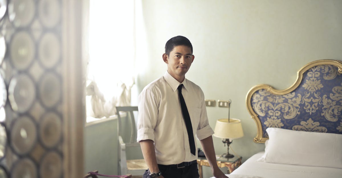 Hotels in Barcelona for People Aged 17? - Ethnic male maid arranging hotel room Hotels in Barcelona for People Aged 17? - Ethnic male maid arranging hotel room