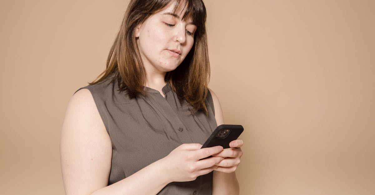 How are overweight surcharges calculated for connecting flights with Spirit? - Focused plump Asian female in stylish wear text messaging on modern cellphone while sitting on beige background in light studio How are overweight surcharges calculated for connecting flights with Spirit? - Focused plump Asian female in stylish wear text messaging on modern cellphone while sitting on beige background in light studio