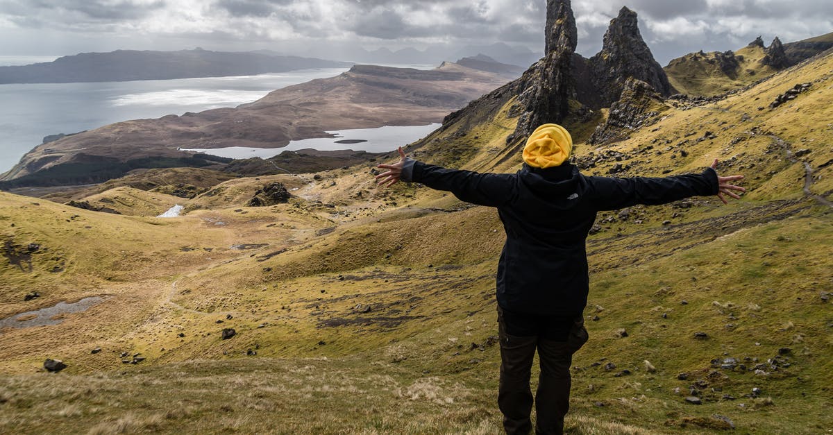 How are Scottish hiking trails marked? - Person Wearing Black Jacket Standing on Green Grass Field Near Lake How are Scottish hiking trails marked? - Person Wearing Black Jacket Standing on Green Grass Field Near Lake