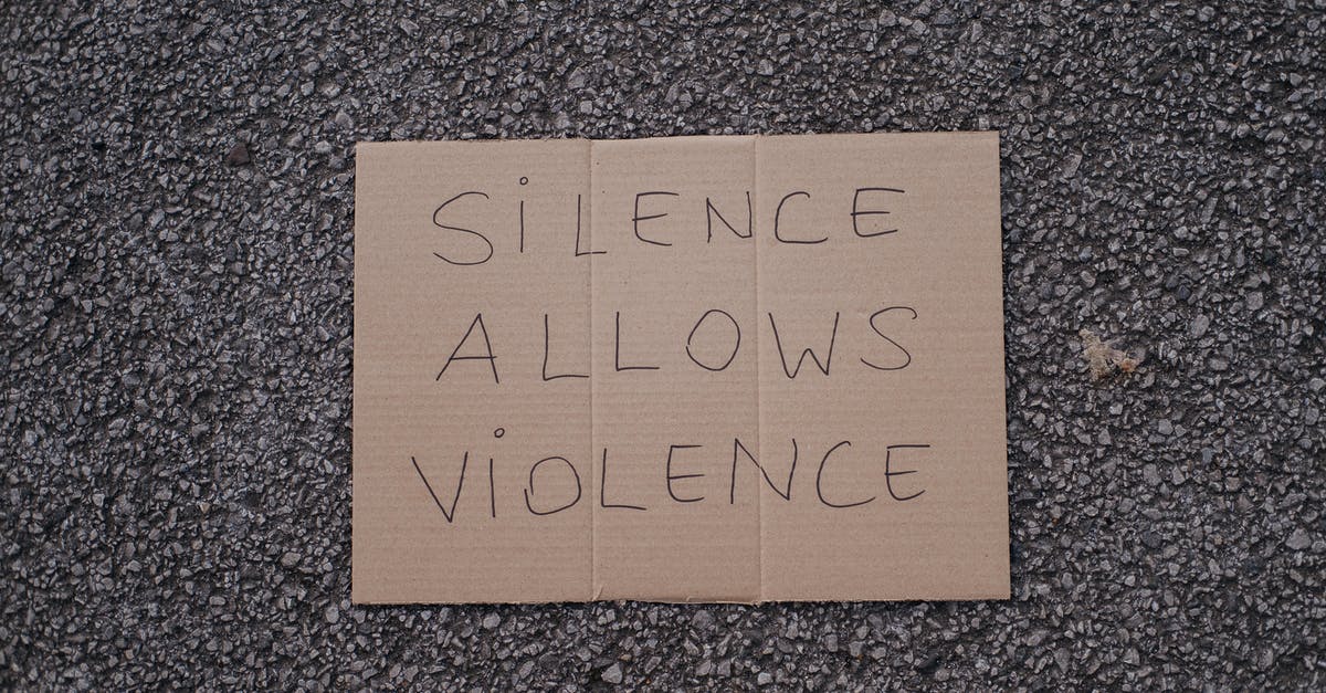 How best to prevent data loss while travelling? - Top view of slogan silence allows violence on carton placed on rough asphalt road on street How best to prevent data loss while travelling? - Top view of slogan silence allows violence on carton placed on rough asphalt road on street