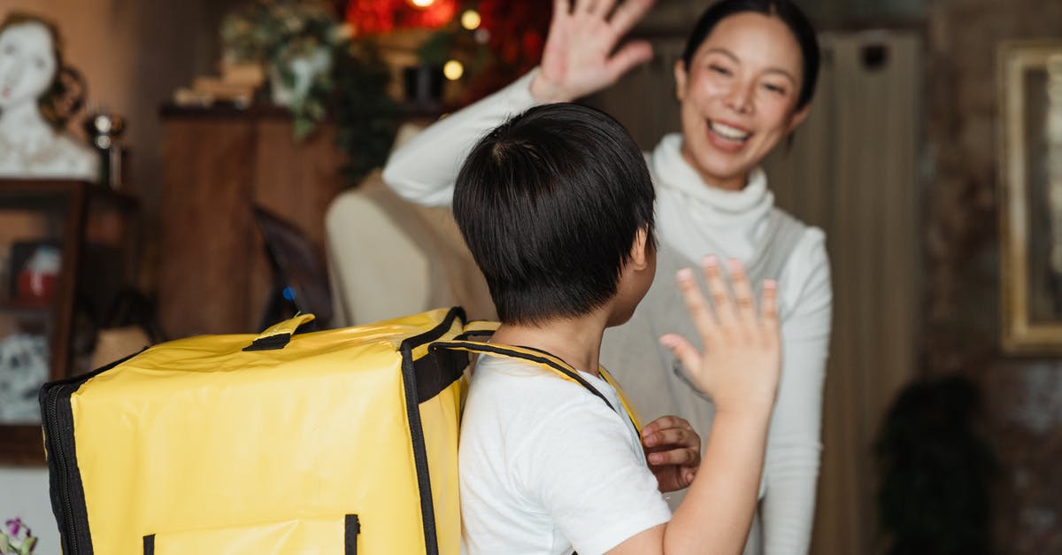 How big of a backpack should I buy? (Trans-Mongolian) - Happy ethnic female cafe worker in apron wishing farewell to boy with food delivery backpack helping in family business How big of a backpack should I buy? (Trans-Mongolian) - Happy ethnic female cafe worker in apron wishing farewell to boy with food delivery backpack helping in family business