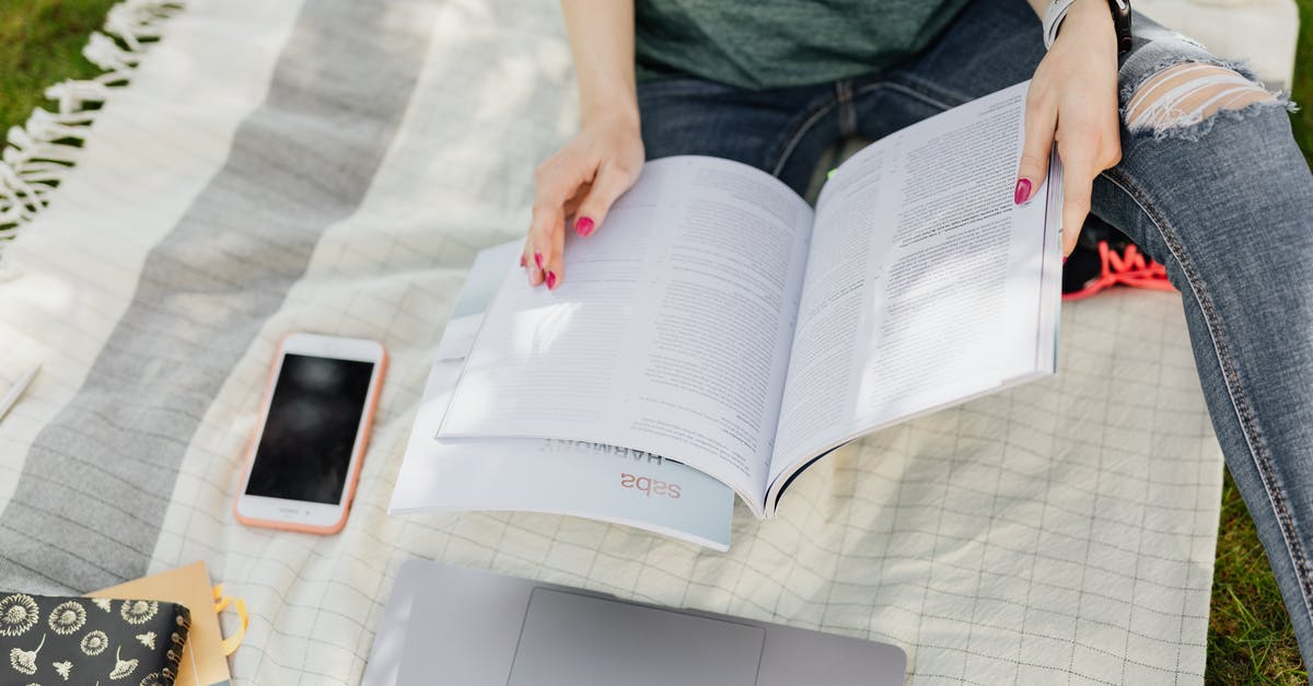 How busy are the Faroe Islands during summer compared to Iceland? - Crop university student reading textbooks on green campus lawn How busy are the Faroe Islands during summer compared to Iceland? - Crop university student reading textbooks on green campus lawn