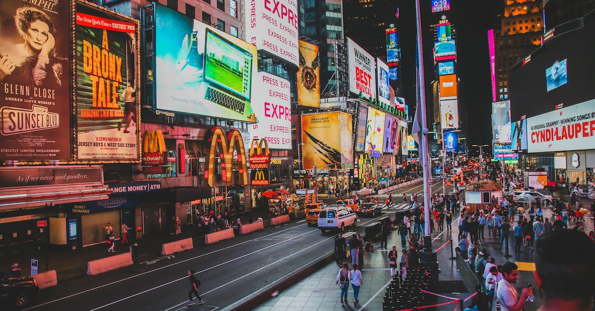How busy is New York City on New Year's Eve? - People Walking on Sidewalk Near Buildings during Night Time How busy is New York City on New Year's Eve? - People Walking on Sidewalk Near Buildings during Night Time