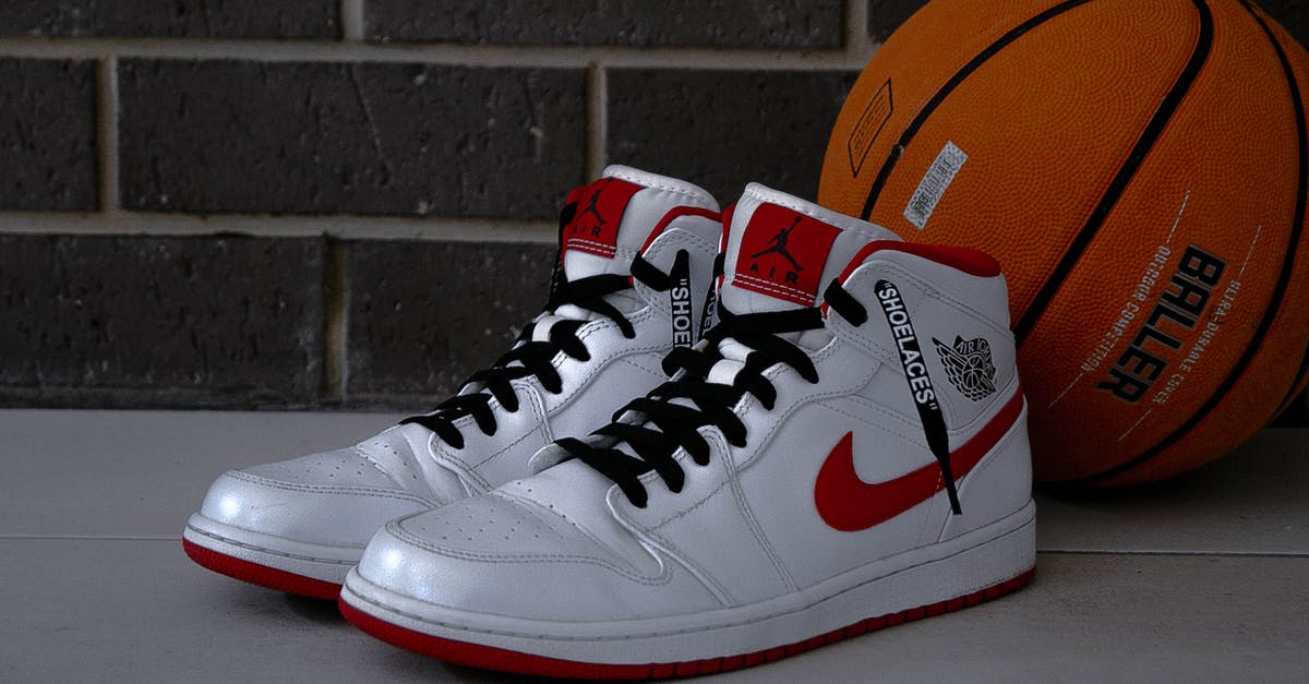 How can 1 carry-on suitcase be tied to 1 checked suitcase, to enable 1 hand to pull both? - Pair of White Air Jordan 1's