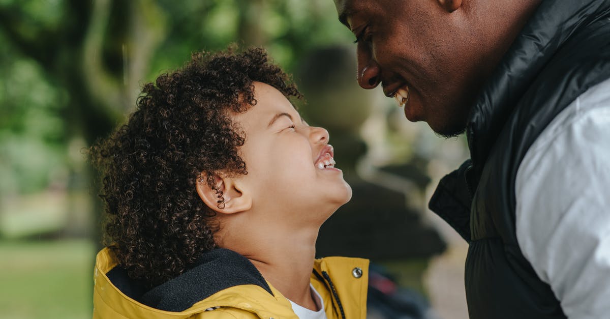 How can a kid fly with one parent and return with the other? - Side view of African American young father smiling while looking on joyful little son with closed eyes on blurred background How can a kid fly with one parent and return with the other? - Side view of African American young father smiling while looking on joyful little son with closed eyes on blurred background