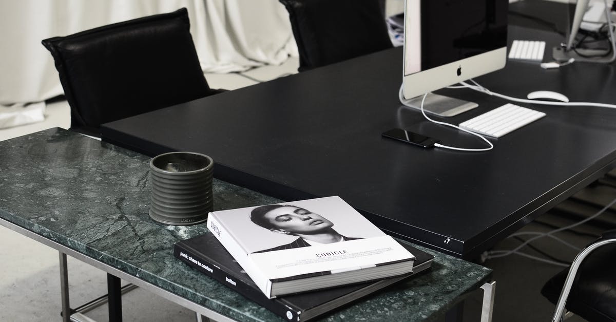 How can AT&T charge me to use WiFi while I'm abroad? - Modern computers and smartphone placed on black table near marble table with books in contemporary workspace How can AT&T charge me to use WiFi while I'm abroad? - Modern computers and smartphone placed on black table near marble table with books in contemporary workspace
