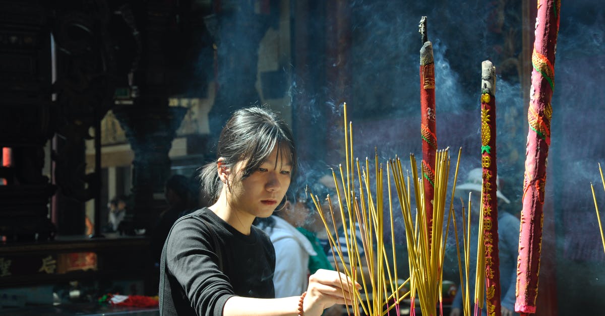 How can I attend an incense ceremony while I'm in Japan? - Woman Lighting Incense Sticks How can I attend an incense ceremony while I'm in Japan? - Woman Lighting Incense Sticks