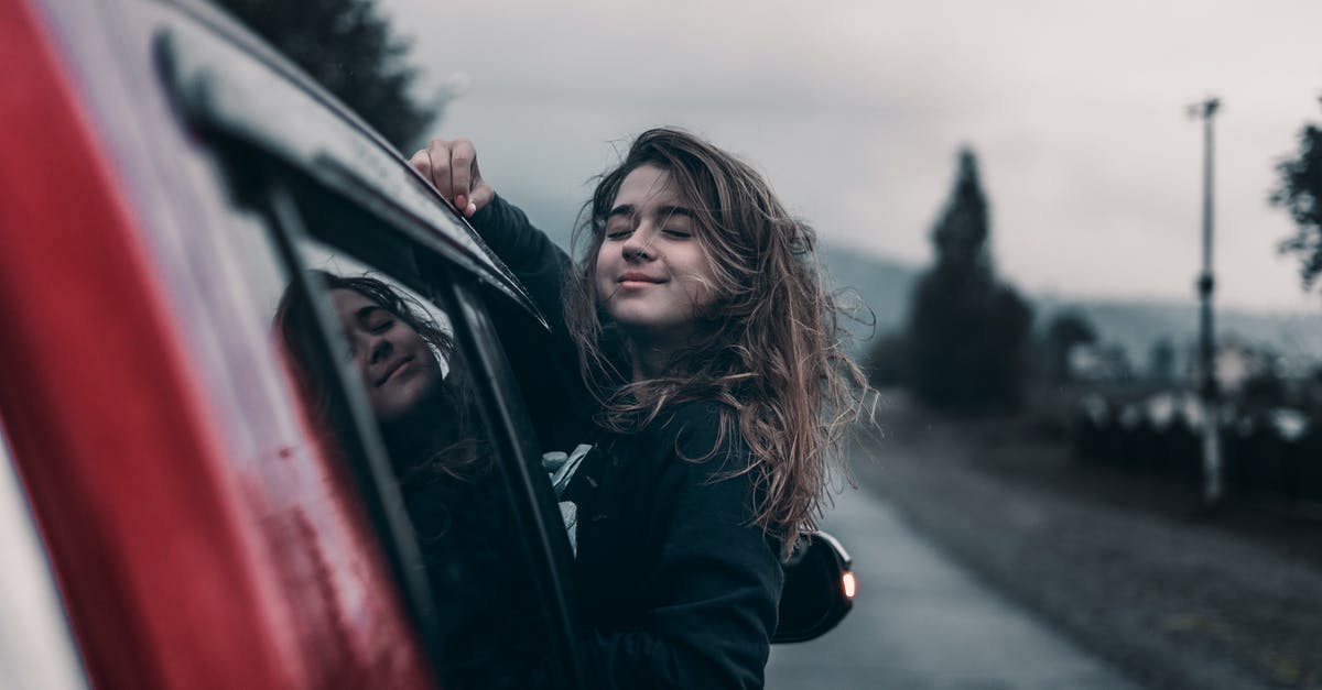 How can I avoid mountain driving between Thunder Bay, Ontario and Moab, Utah? [closed] - Side view of young dreamy ethnic female with closed eyes leaning out automobile window driving on asphalt road near trees and mountains under sky in countryside