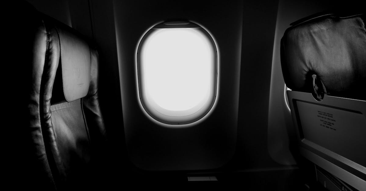 How can I be assured a seat on the plane? - Grayscale of Airplane Window and Chair How can I be assured a seat on the plane? - Grayscale of Airplane Window and Chair