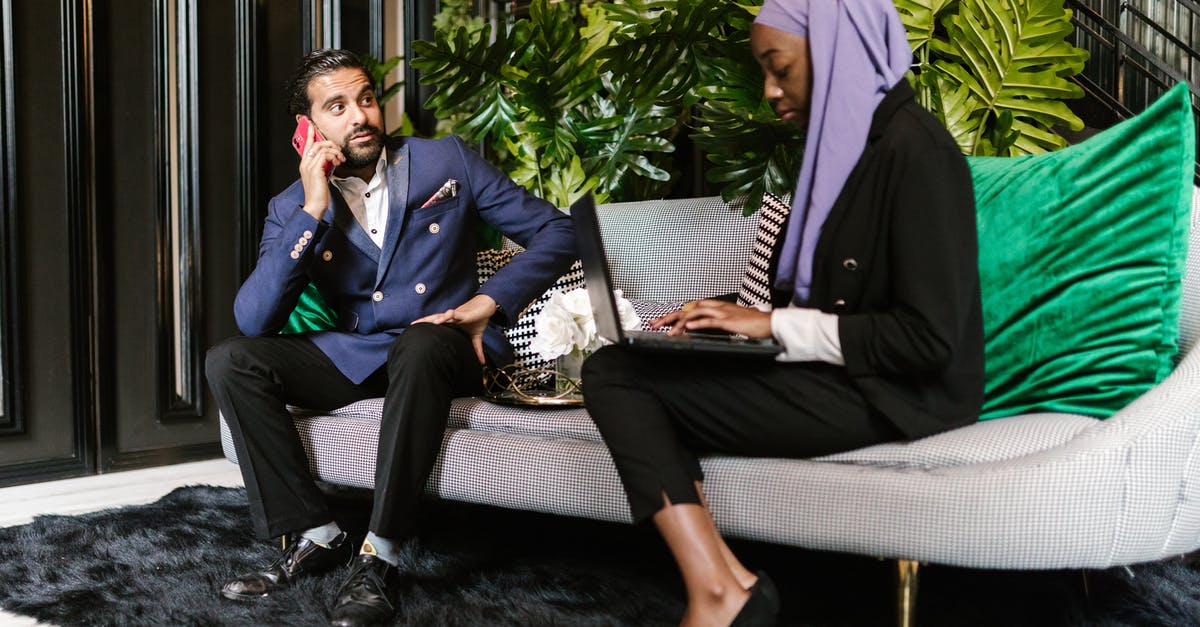 How can I deal with extreme temperatures in a hotel room? - Man and Woman Sitting on Gray Couch How can I deal with extreme temperatures in a hotel room? - Man and Woman Sitting on Gray Couch